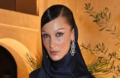 Bella Hadid le canalizează pe Marilyn și Madonna într-un bob blond platină creț — urmăriți videoclipul