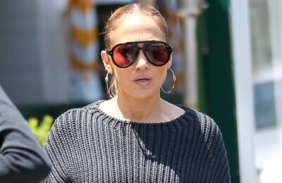 J Lo poartă blugi largi cu talie joasă și un pulover cropped