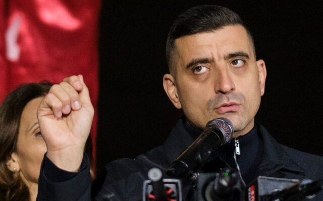 Lider politic la microfon cu pumnul ridicat in