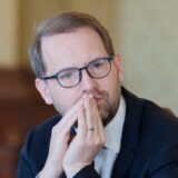 Barbat cu mainile impreunate la fata, ingandurat